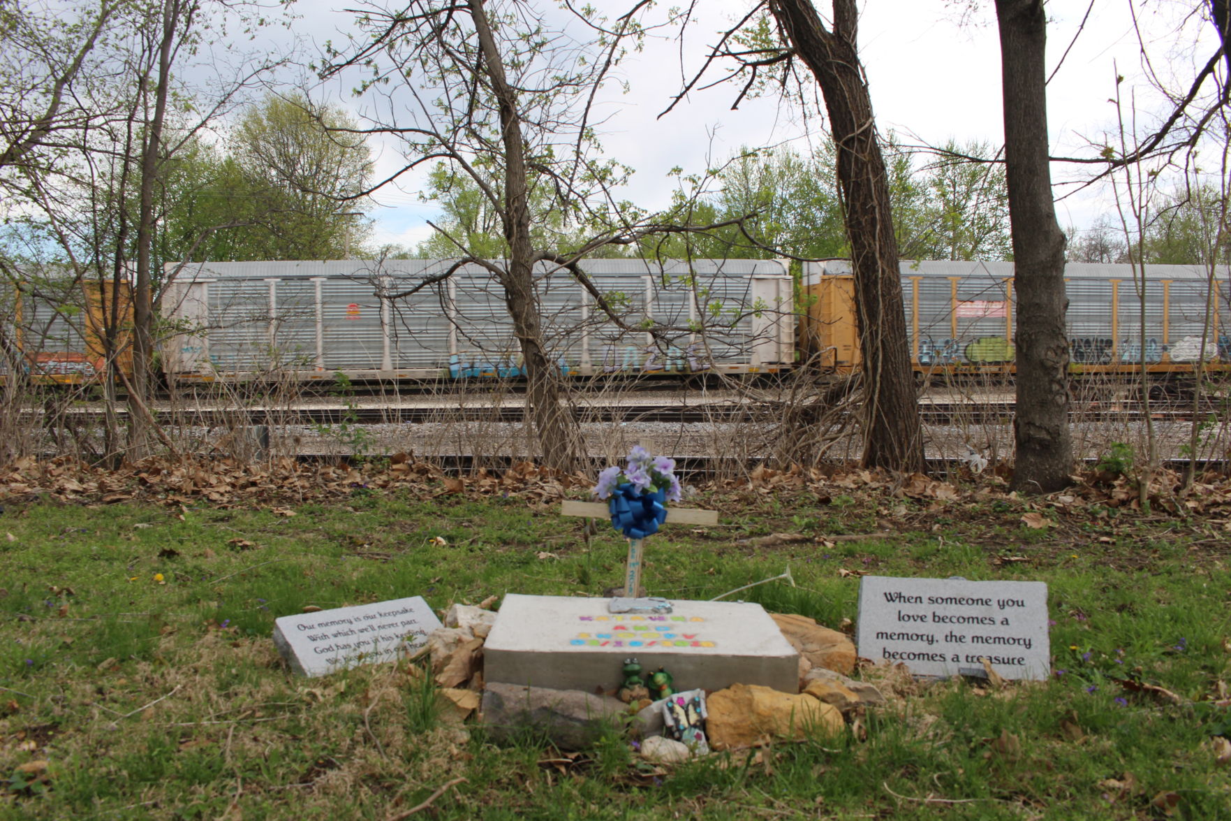 A train flies past Katawna's memorial next to the tracks